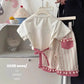 Bow print short sleeve set on a young girl during a relaxed daytime moment