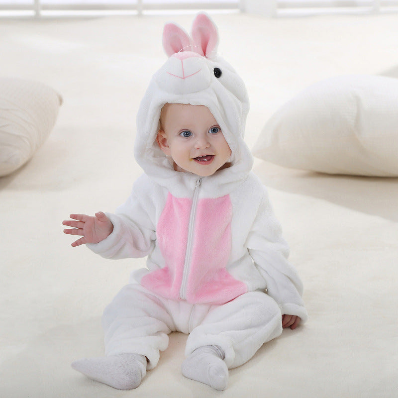 Baby in a white rabbit flannel romper with a pink belly panel, sitting on a white rug beside cushions
