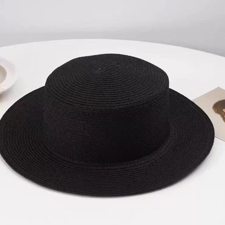 Wide brim straw sun hat shown in natural light to bring out the woven texture