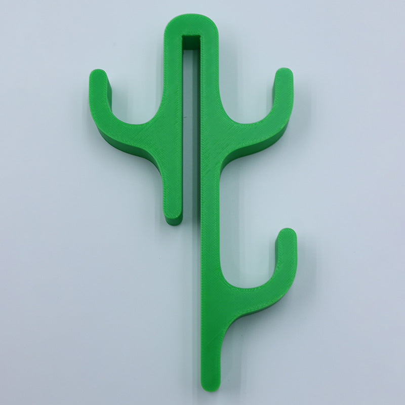 Green resin three hook with three arms, seen from the front on a light background