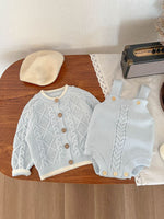 Knitted suspender baby set cardigan and pants shown from the front
