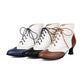 Vintage brogue lace up ankle boot in two tone cream with round toe, wingtip perforations and a low spool heel