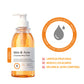 Clear GMH pump bottle of amber body wash beside a round logo mark and three ticked lines