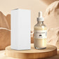 True Belly Serum dropper bottle beside its plain white box on a wood stand against a soft sand colored backdrop