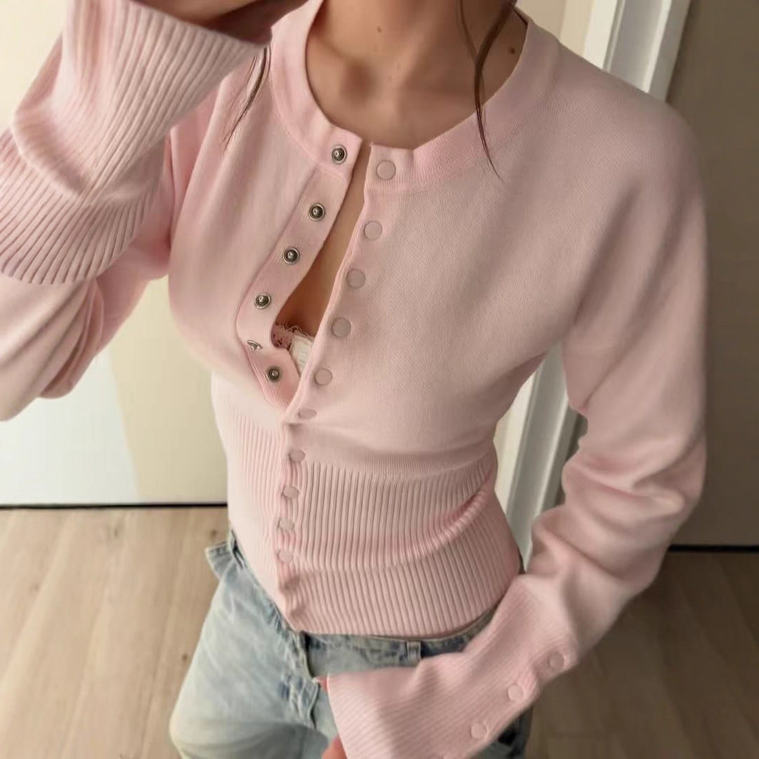 Pink rib knit cardigan seen from the front with the fitted waist and round neck