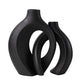 Two ceramic vases nested together with a small dried arrangement