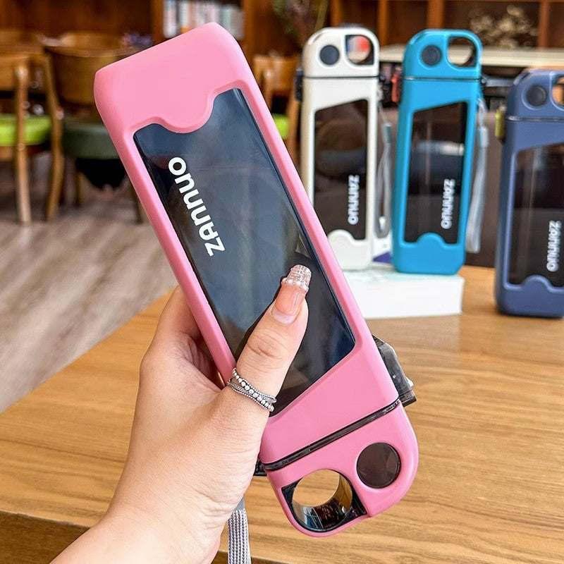 Pink square plastic water bottle held in hand with white blue and navy bottles lined up behind