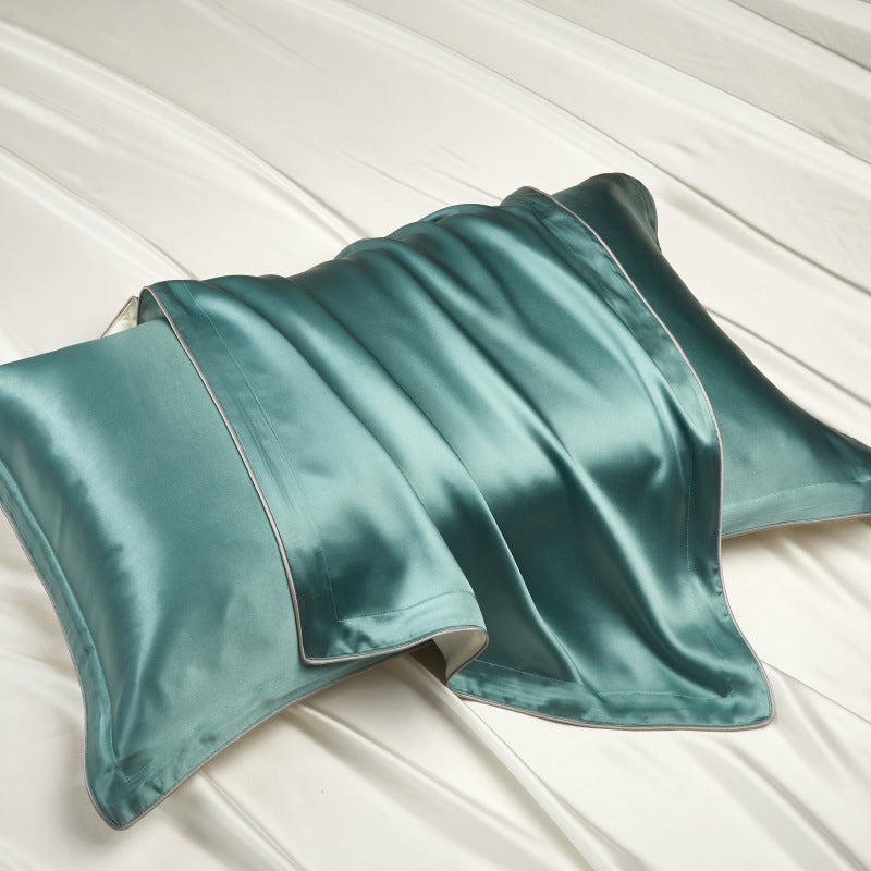 Mulberry silk pillowcase with a contrast piped edge laid flat on white