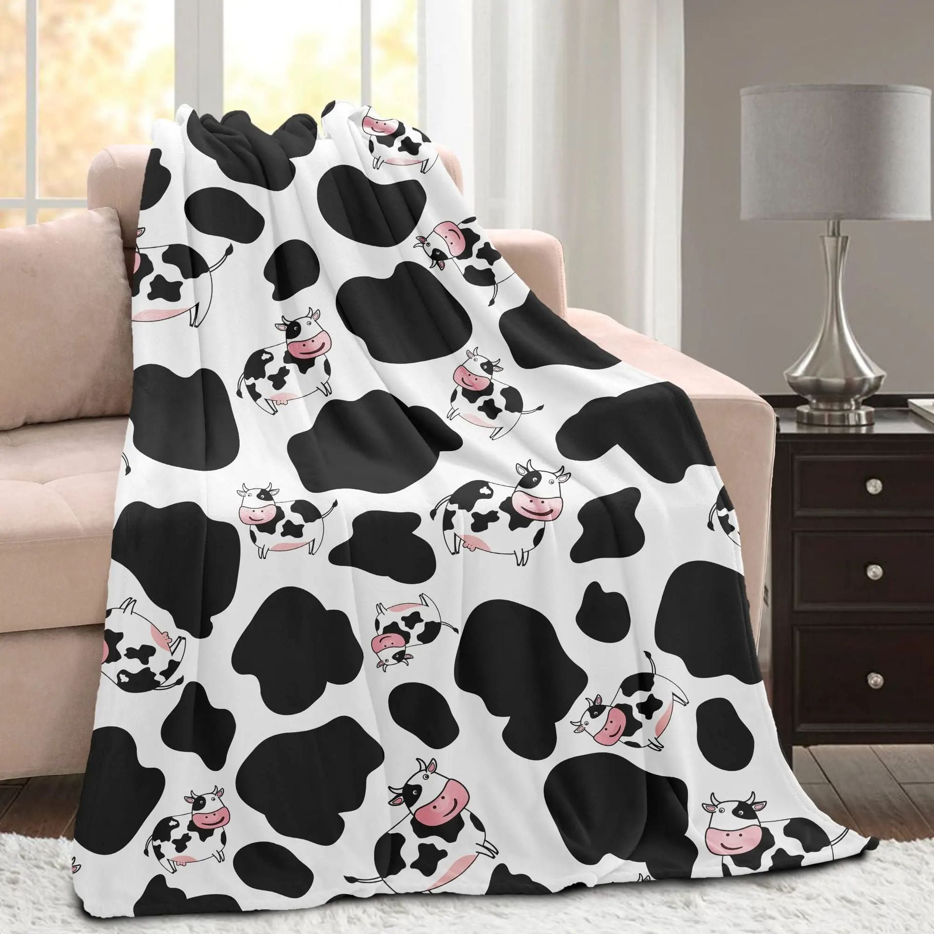 Close up of soft brushed flannel showing black and white cow pattern