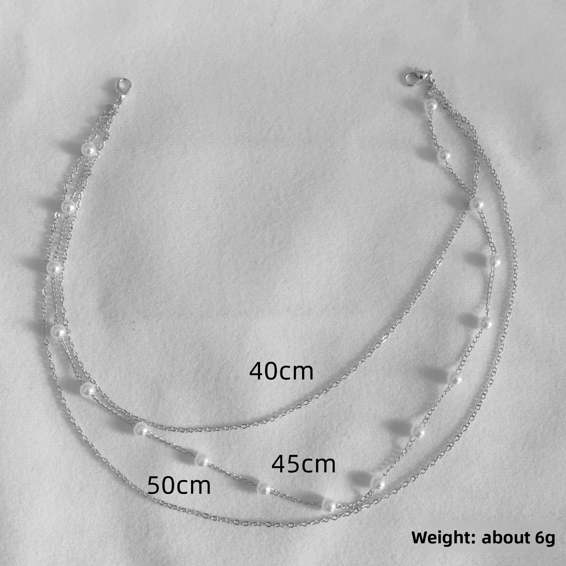 Layered rhinestone Y drop necklace shown flat to reveal both chain lengths