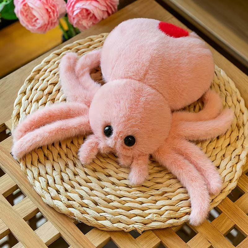 Group of reversible spider plush dolls showing the two face mood design