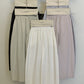 Cotton wide leg trousers grouped on hangers in cream, lilac and carbon ash