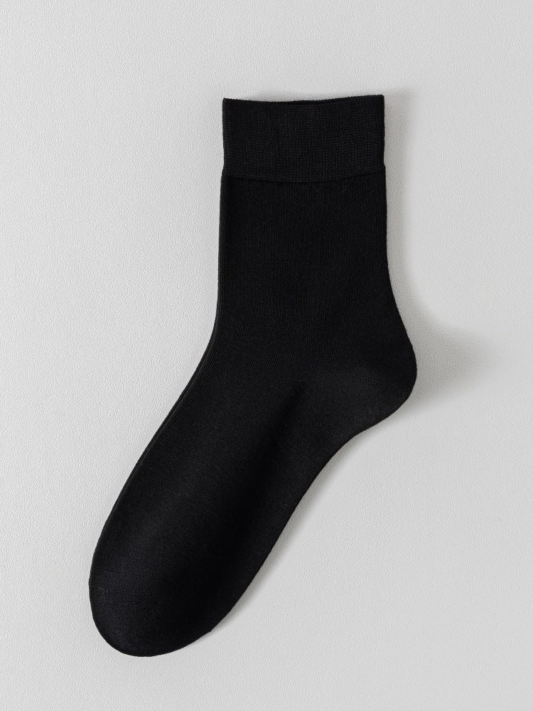 Black bamboo viscose blend mid calf sock laid flat on a pale background