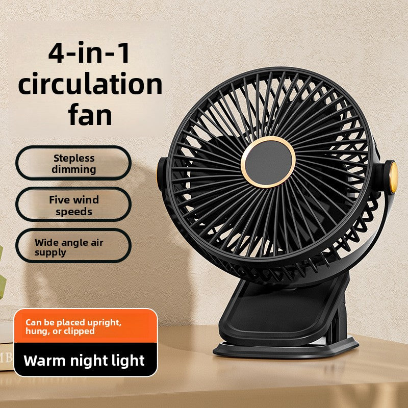 Black clip fan on a desk with its clamp folded flat, warm hub light in the grille centre