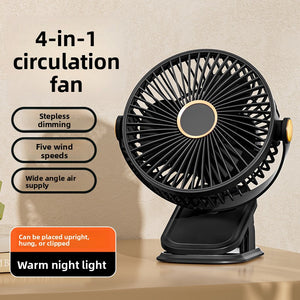 Black clip fan on a desk with its clamp folded flat, warm hub light in the grille centre