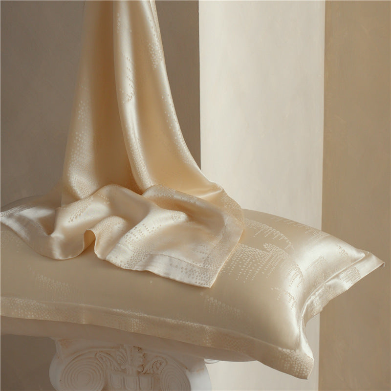 Rippling Light jacquard silk pillowcase in cream with silk draped over it, pair option