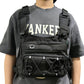 Water bladder and drinking tube laid beside the chest pack on a plain background