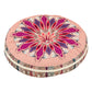 Round cushion with a magenta pink mandala print top and a pink striped side on a white background