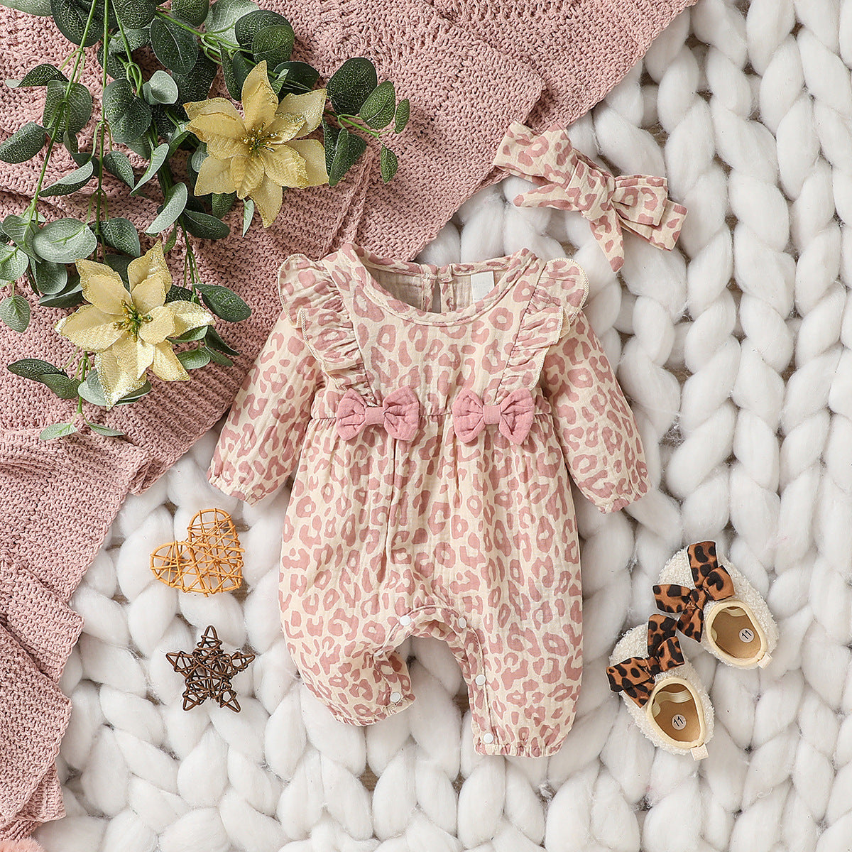 Side profile of baby floral romper showing the soft fabric drape