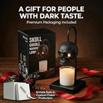 Black skull candle warmer lamp on a heavy metal base warming a jar candle placed beneath the skull