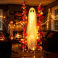 Close view of the mesh ghost face and glowing body of a hanging Halloween decoration
