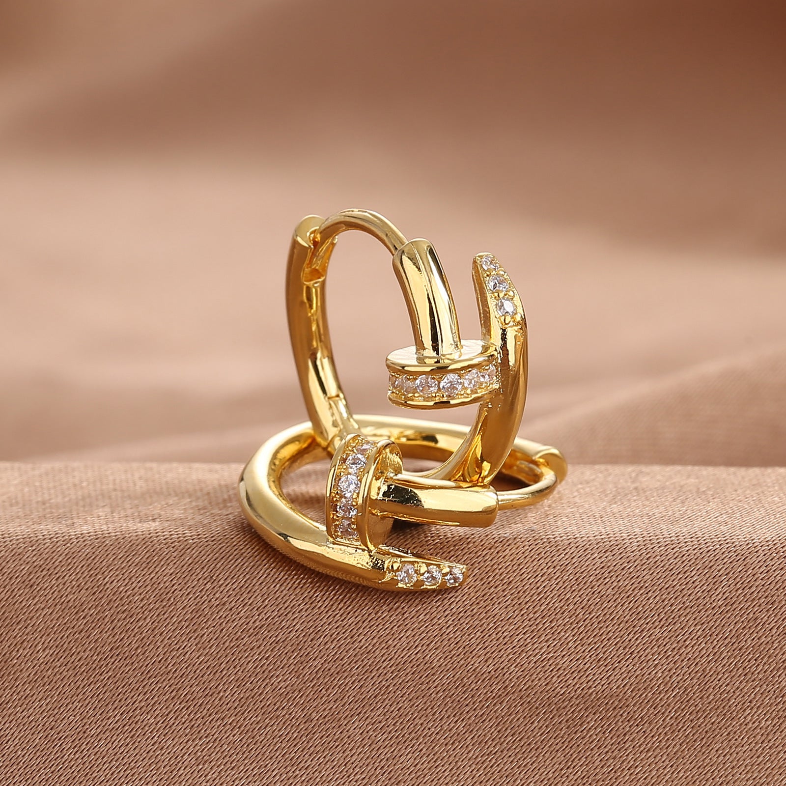 Zirconium nail stud earrings worn on the lobe in a styled ear stack