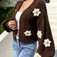 Side view of the open front knit cardigan showing the lantern sleeve and flowers