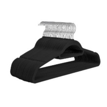 Black flocked hangers stacked together with silver hooks on a white background