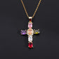 Gold tone cubic zirconia cross pendant with a shaped bail and lobster style clasp