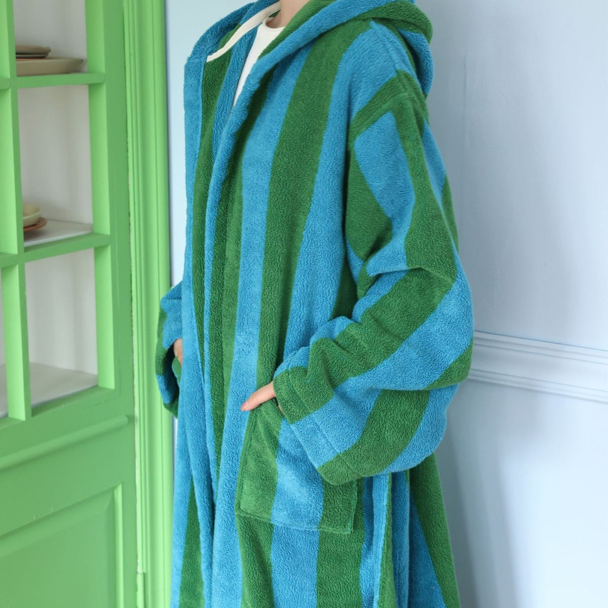Blue and green wide striped hooded cotton terry bathrobe with turned back cuffs and a front patch pocket