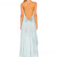 Angled styling shot of the Jade Green asymmetrical hem dress with bare shoulders