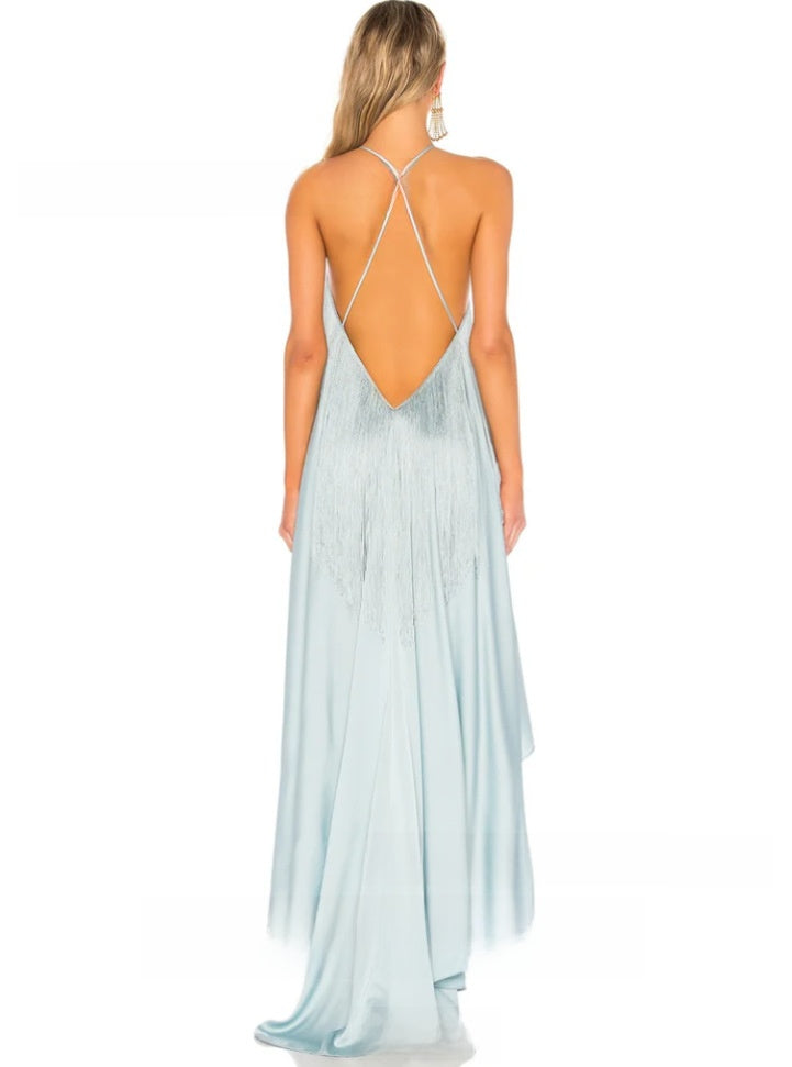 Angled styling shot of the Jade Green asymmetrical hem dress with bare shoulders