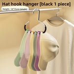 Circular hat hanger ring held in hand showing its round 14 by 15cm scale