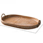 Large oval rattan tray with woven base, studded wooden rim and two arched handles on white, Large size option