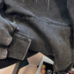 Ribbed cuff and hem detail of the washed black hooded sweatshirt