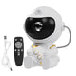 White astronaut projector shown with its remote control and braided USB charging cable