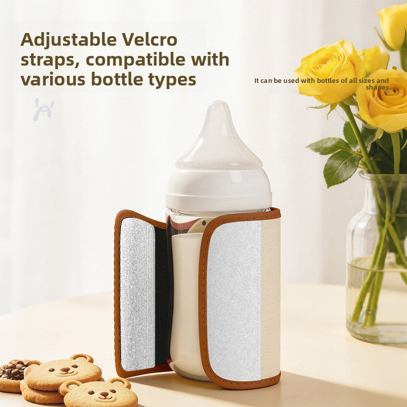 Open warmer sleeve showing the adjustable Velcro strap and inner lining wrapped around a baby bottle
