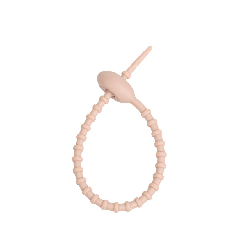 Close view of the ridged silicone strap and the tadpole head that holds the loop