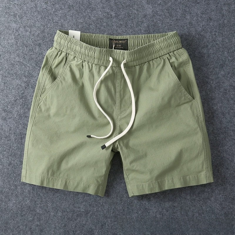Army green men's cotton drawstring shorts laid flat with the drawstring untied