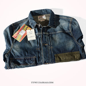 Folded retro denim jacket showing vintage paper hang tags and notch lapel collar