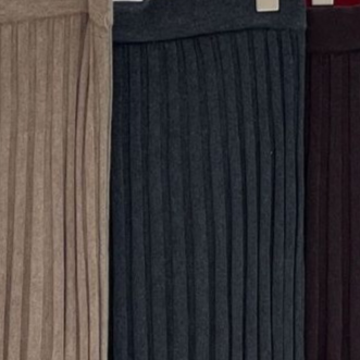 Close up of ribbed knit swatches in tan, deep gray and dark burgundy