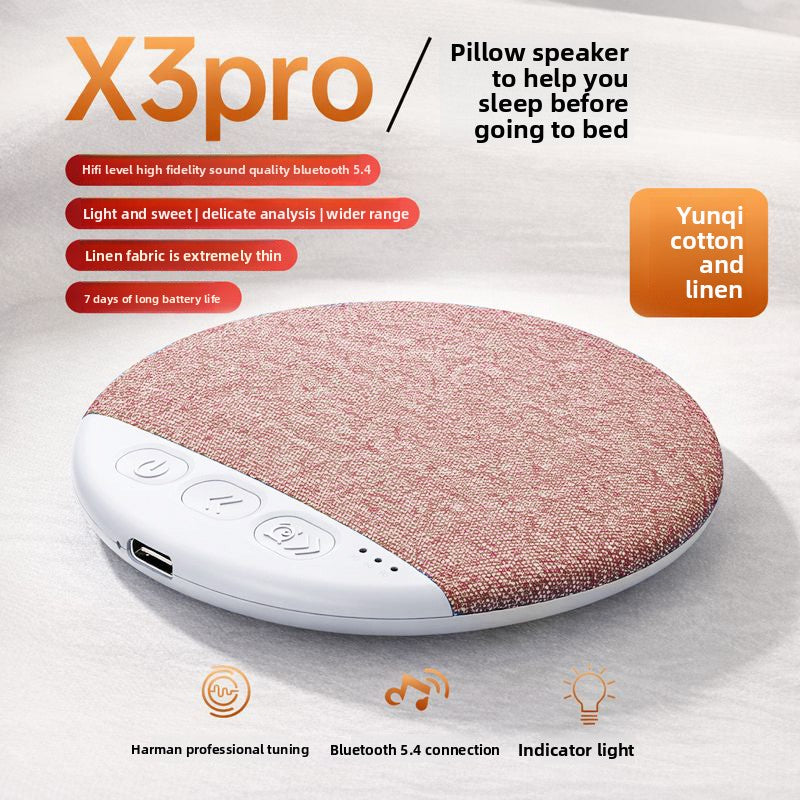 Denim blue pillow speaker on a bed sheet showing the woven top face