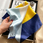 White blue and navy color block printed square scarf with a satin sheen and hemmed edges, shown displayed