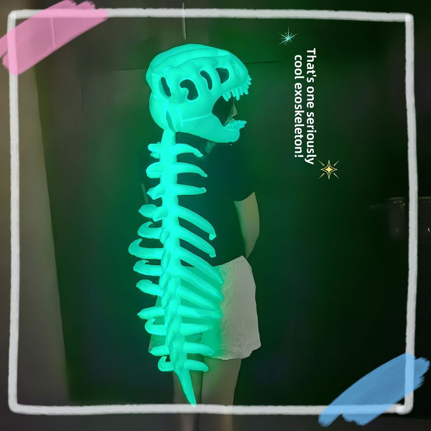 Child in profile wearing a glowing green dinosaur skull and ribbed spine costume in a dark room
