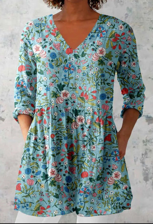 Loose fit printed V neck tunic shown on a model over slim trousers