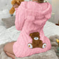Pink plush hooded romper with bear ears and a teddy bear back patch, shown on the Pink size S option