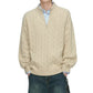 Cream half zip cable knit sweater with dropped shoulders on a model against a white background, torso view