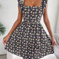Floral square neck ruffle strap mini dress with a shirred bodice on a standing model, side view