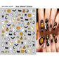Halloween nail decals shown as a finished manicure with skulls and pumpkins