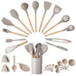 Khaki silicone kitchen utensil set fanned out around its crock, measuring cups and spoons alongside